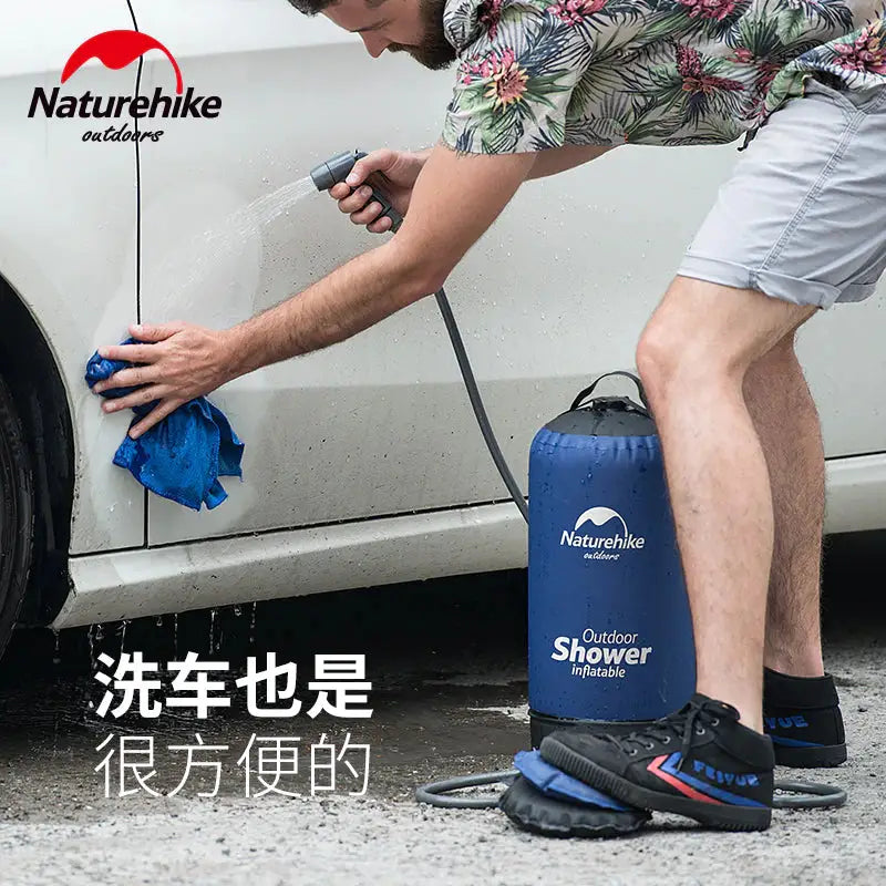 a man washing his car with a blue cloth