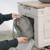 a person putting a bag into a cooler