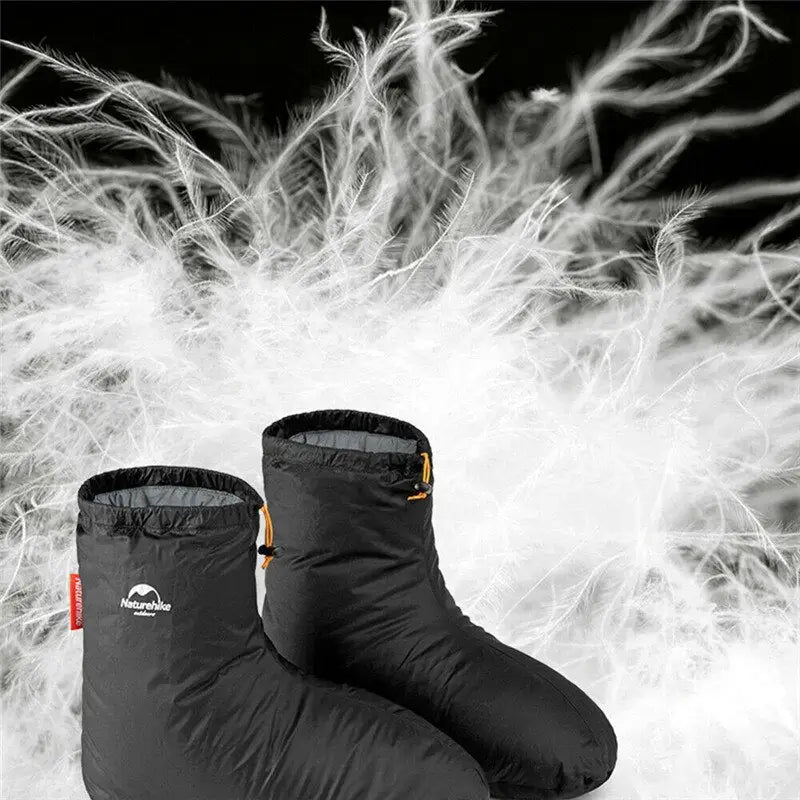 a pair of black boots with white snow on them