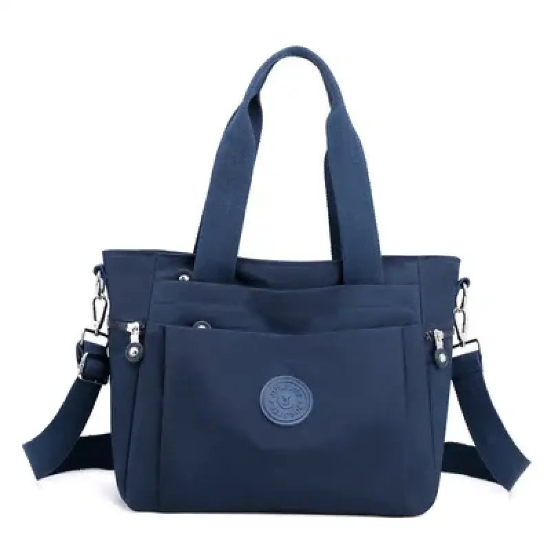 a navy blue bag with a small logo on the front