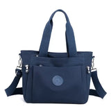 a navy blue bag with a small logo on the front