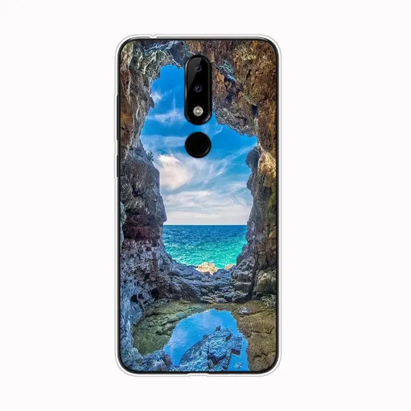 a close up of a cell phone with a picture of a beach