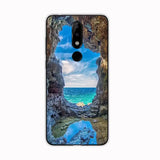 a close up of a cell phone with a picture of a beach