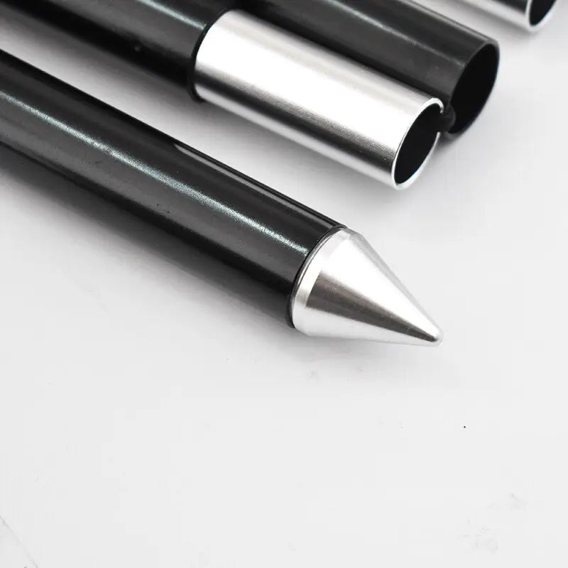 three black and silver pens on a white surface