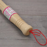 a wooden stick with a red string on it