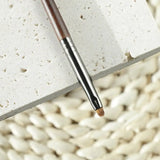 a pen on a white surface