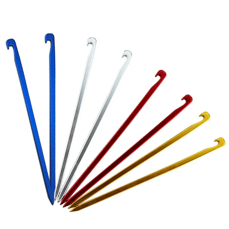 a close up of a group of metal knitting needles on a white surface