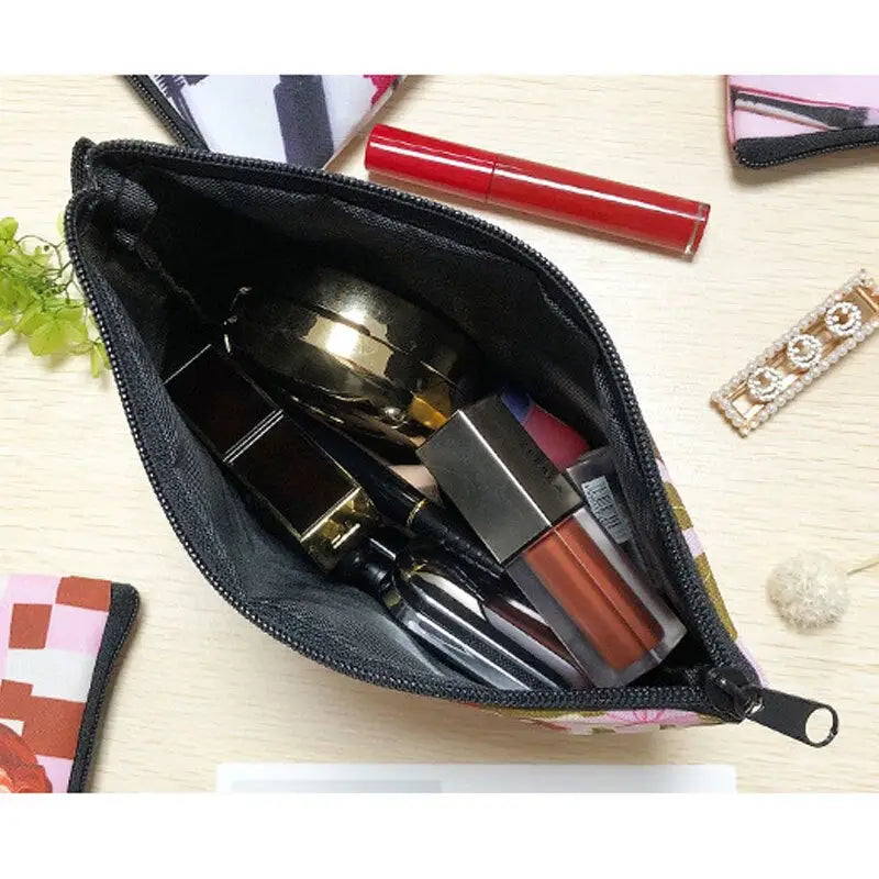 a black purse with lipstick and lipstick brushes