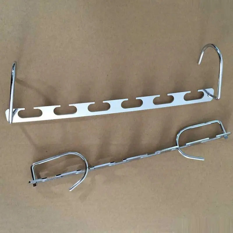 a pair of metal brackets on a brown background