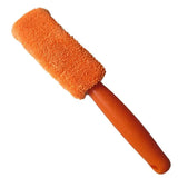 a orange brush with a long handle