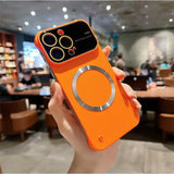 a person holding an orange phone case