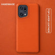 the back of an orange leather case with the text handmade