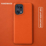 the back of an orange leather case with the text handmade