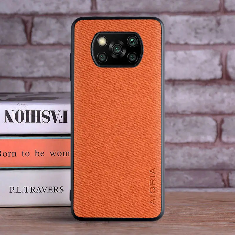 the back of an orange leather case for the iphone