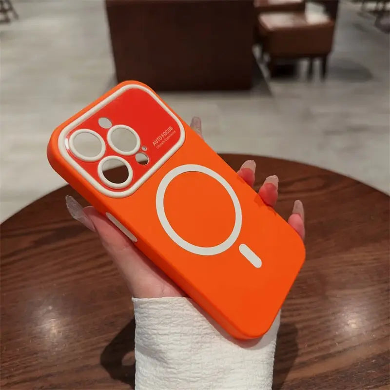 a hand holding an orange phone case