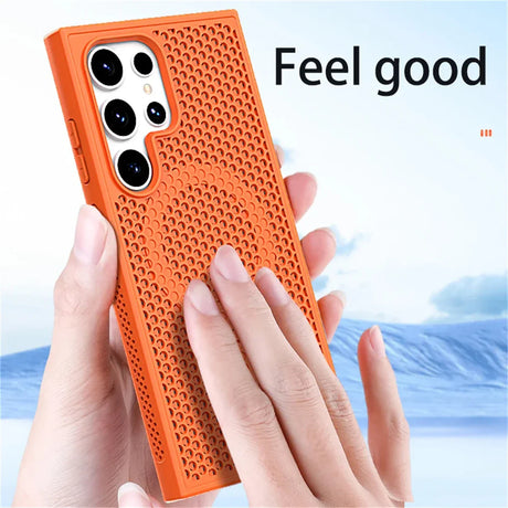 Orange textured phone case with multiple camera cutouts being held by hands.