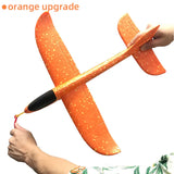 a person holding a orange plane with a black handle