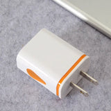 a white and orange charger on a gray surface