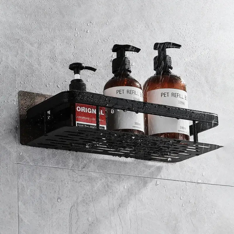 a black shelf with two bottles of liquid on it