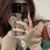 araffe girl taking a selfie with her phone while wearing a sweater
