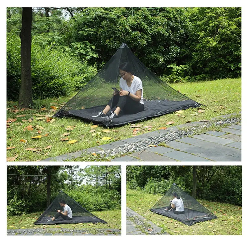 a man sitting on a blanket in the grass