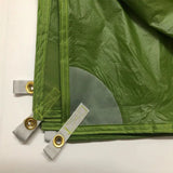 a green jacket with a zipper and two gold rings
