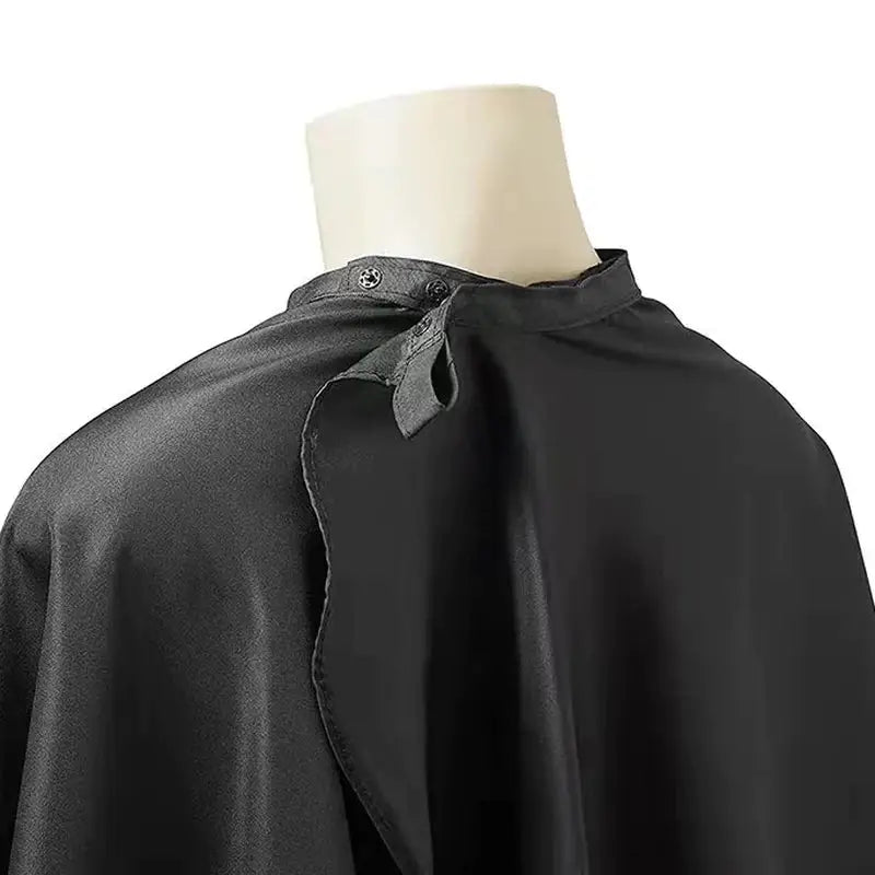 a close up of a black cape on a mannequin dummy