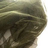 a piece of green mesh on a white surface