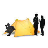 a man and woman are setting up a tent