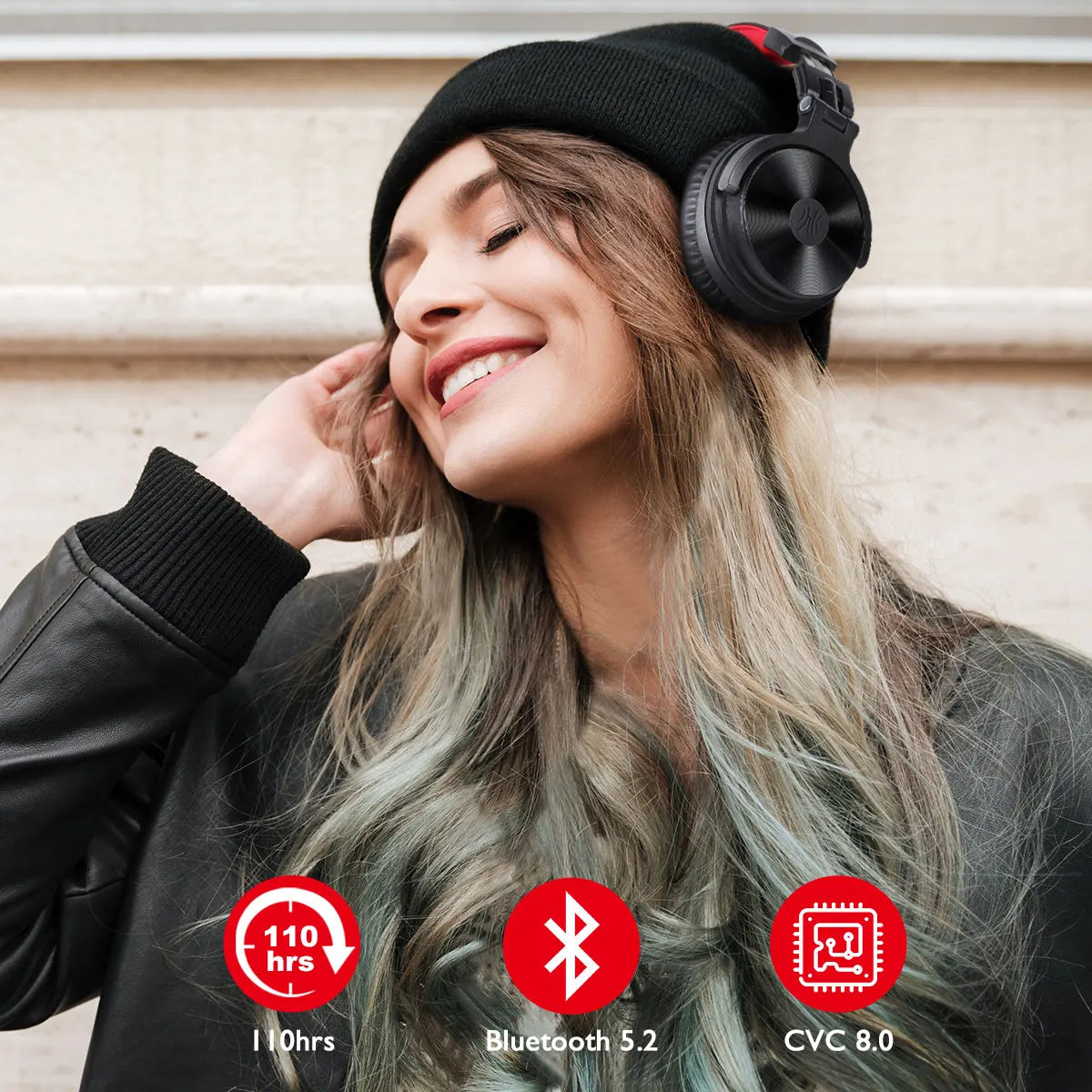 Over-ear wireless headphones worn by a smiling woman in a beanie hat.