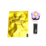 a yellow packet with a purple flower and a black strap