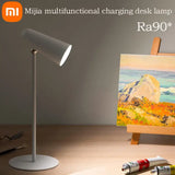 a painting on a ease with a lamp and paintbrush