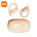 Pair of beige wireless earbuds with ear hooks and matching charging case.