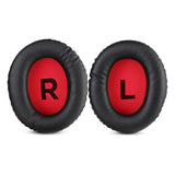 Pair of black headphone ear cushions with red centers labeled ’R’ and ’L’.