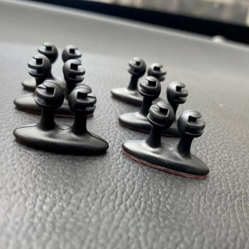 a pair of black metal knobs on a car dashboard