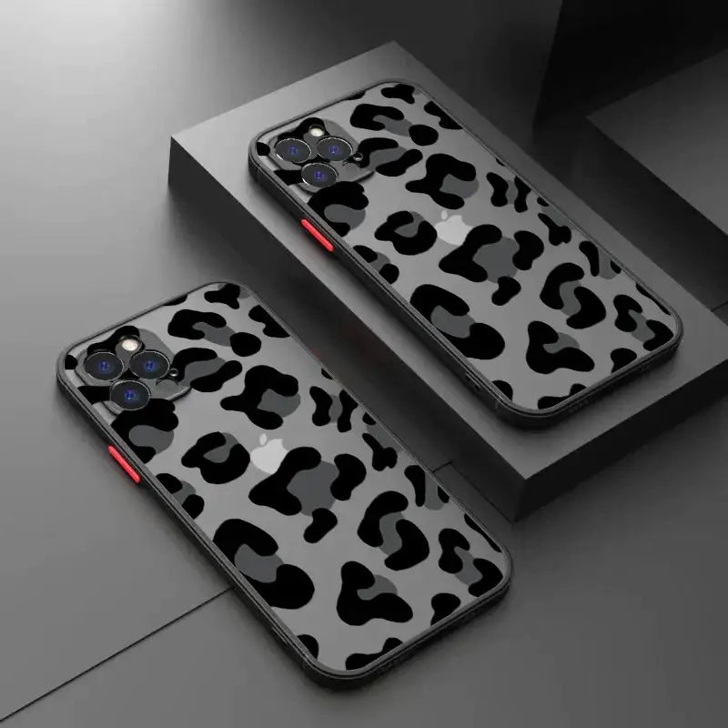 A pair of black and white leopard print cases on a table