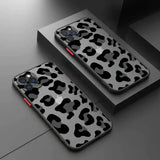 a pair of black and white leopard print cases on a table