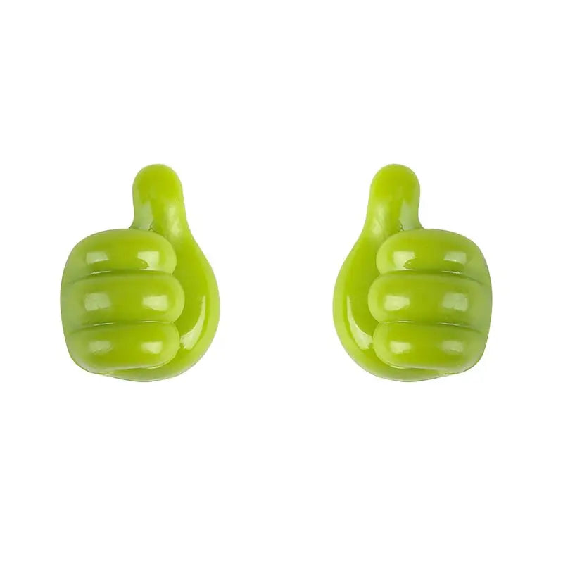 pair of green thumbs up earrings on white background