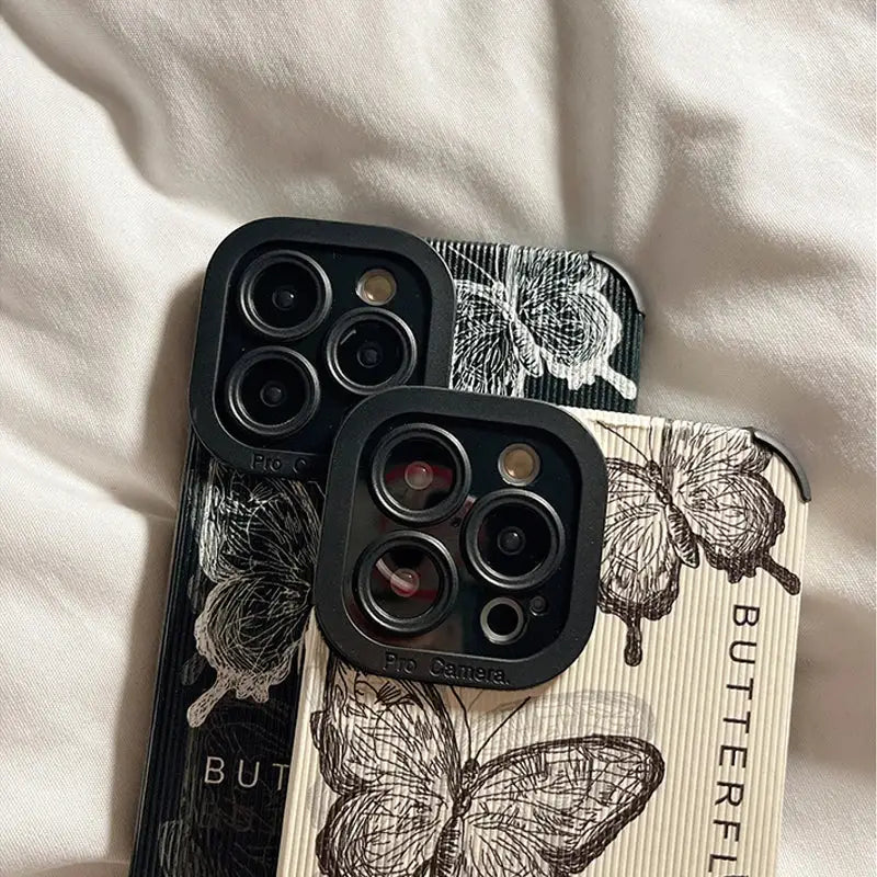 a pair of iphone cases with a butterfly design