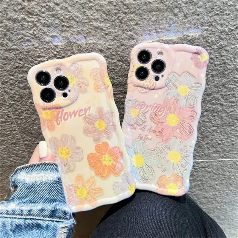 a pair of iphone cases with flowers on them