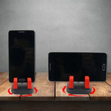 a pair of iphones with a charging station