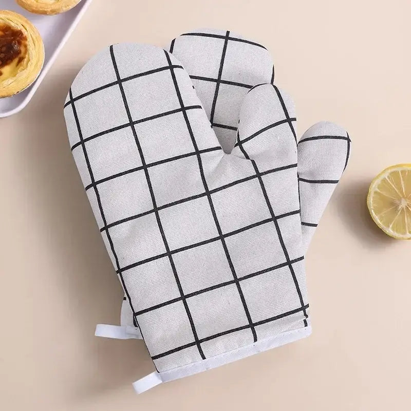 a pair of oven mits with a lemon on the side