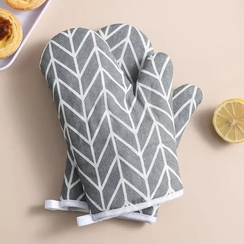 a pair of oven mits with a lemon and lemon