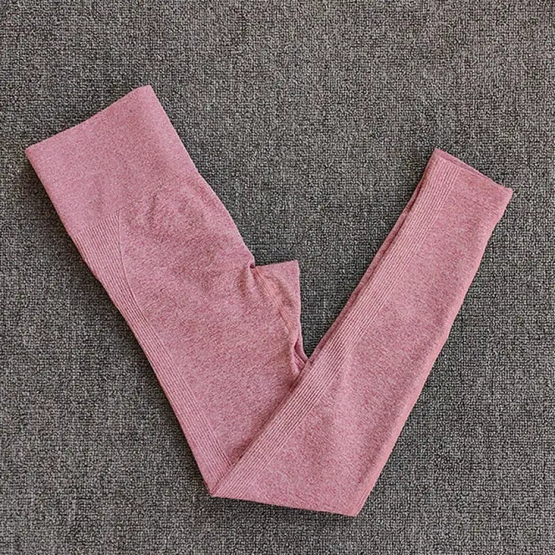 a pair of pink leggings on a gray background