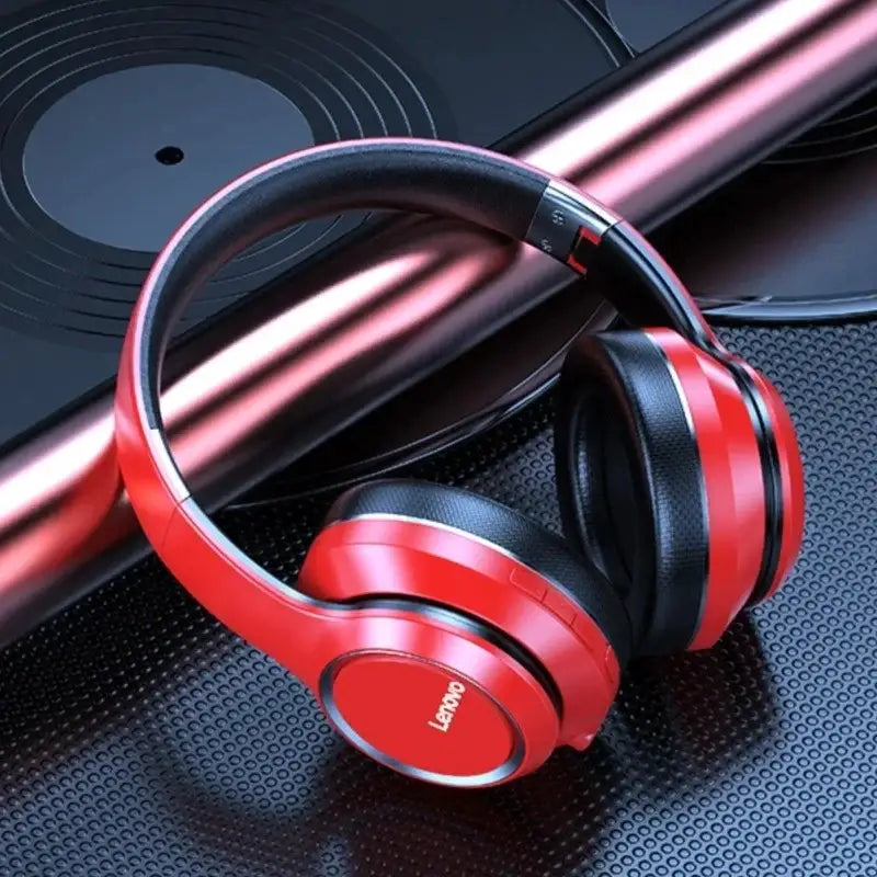 a pair of red headphones on a black surface