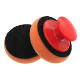 a pair of sponges with a red button