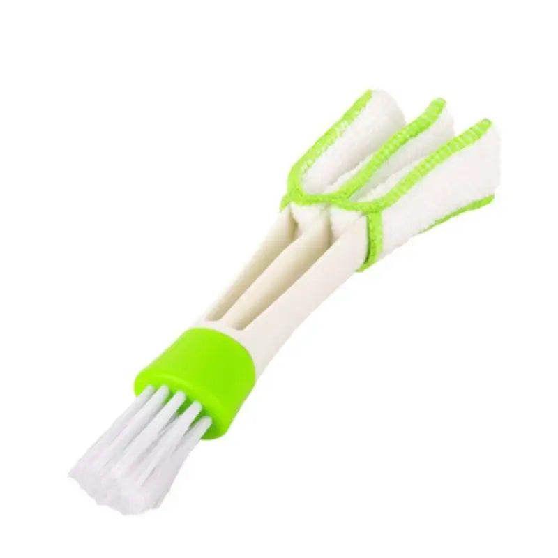 a pair of white and green plastic handled brushes