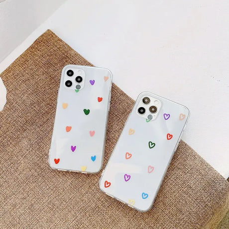 A pair of white phone cases with colorful hearts on them