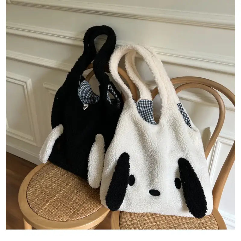 a panda bear bag sitting on top of a chair