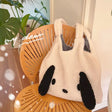 a panda bear bag sitting on a chair